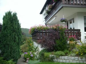 una casa con un balcón con flores. en Ferienwohnung Waltraud, en Brilon