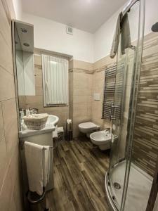 a bathroom with a shower and a sink and a toilet at Exclusive Mood Apartment in Rome