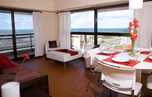 a living room with a view of the ocean at Solanas Playa Mar del Plata in Mar del Plata