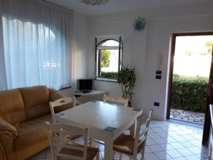 a living room with a table and a couch at La casa Bianca in Maratea