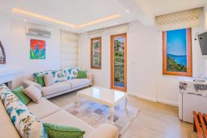 a living room with a couch and a table at Amphora Hotel in Kaş