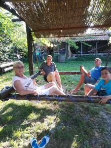 a group of people sitting on a rope swing at ART STUDIO capitain in Sinemorets