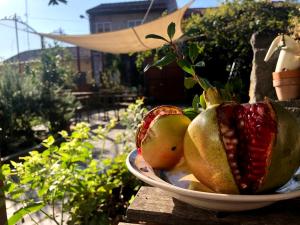 a bowl of fruit sitting on a wooden table at B&B Polifemo Etna in Nicolosi