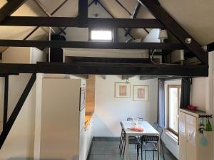 a kitchen and dining room with a table and chairs at vakantiehuisje 007 in Koksijde