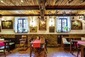 a restaurant with tables and chairs and paintings on the wall at Schloß Destille in Dormagen