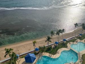 an aerial view of a swimming pool and the beach at Beachfront, Juandolio in Juan Dolio