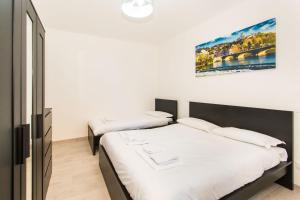 Ліжко або ліжка в номері Piazza Statuto Comfortable Apartment