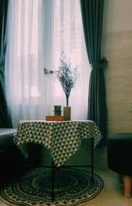 a table with a table cloth on it in front of a window at Lighthouse Homestay Vũng Tàu in Vung Tau