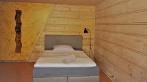 a bedroom with a bed in a room with wooden walls at Apartament Fiedorówka in Zakopane