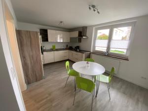 a kitchen and dining room with a table and chairs at Schöne Ferienwohnung in Landsberg in Landsberg
