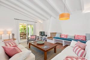 a living room with a couch and a table at Villa Sirena - Cap den Font in Binisafua