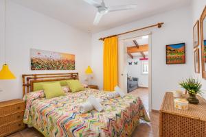 a bedroom with a bed with a colorful bedspread at Bellamirada - Punta Prima Playa in Punta Prima