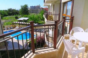 a balcony with a view of a swimming pool at Бяла Виста Бийч Апартментс A - Byala Vista Beach Apartments A in Byala