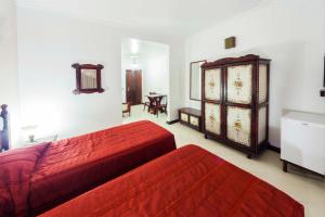 1 dormitorio con 2 camas y vestidor en Hotel Tannenhof en Joinville