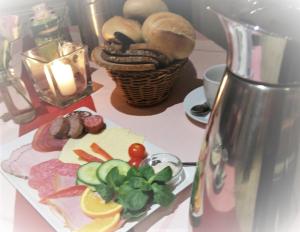 a table with a plate of food and a blender at Hotel & Restaurant Alte Molkerei Kölleda in Kölleda