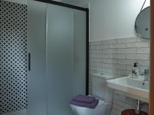 a bathroom with a toilet and a sink at Parga Natura Alojamiento in Parga +31 photos