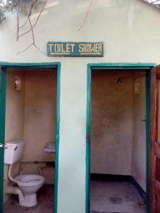 an old toilet shed with a toilet sink and a sign at Naumba Camp and Campsite in Ngoma