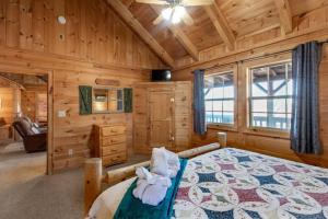 a bedroom with a bed in a log cabin at Amazing Views! Hot Tub,Pool Table,Fireplace,Relax! in Gatlinburg