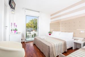 una camera d'albergo con letto e bagno di Hotel Palace a Lignano Sabbiadoro