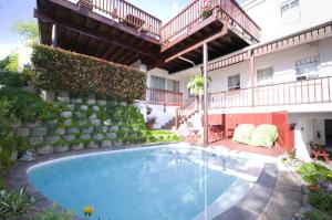 a swimming pool in front of a building at Knysna Manor House in Knysna