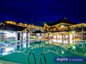 a swimming pool in front of a hotel at night at Lou Condo Rental in Cagayan de Oro