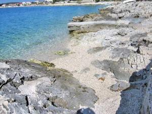 a rocky shore with the ocean and the water at Apartments Ivan in Sevid