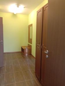 a bathroom with a door and a tiled floor at Azalya Hotel in Kazan