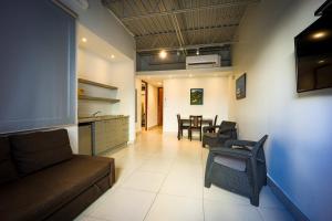 a living room with a couch and a table and chairs at Coral Suites in San Juan