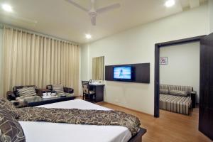 a hotel room with a bed and a television at Best Western Swing High Katra in Katra