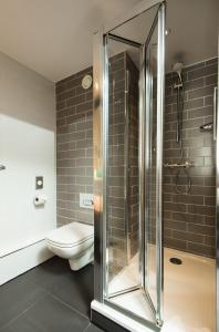 a bathroom with a shower and a toilet at Holiday Inn Express Burton on Trent, an IHG Hotel in Burton upon Trent