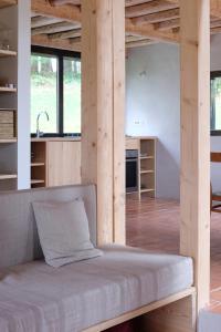 a room with a bed and a kitchen at Chalet d'Orti in Sainte-Ode