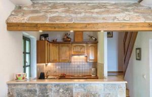 cocina con armarios de madera y encimera de piedra en Holiday Home Tonia, en Baška Voda