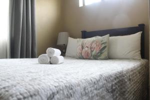 a bedroom with a bed with towels on it at The Anne Guest House in Maseru