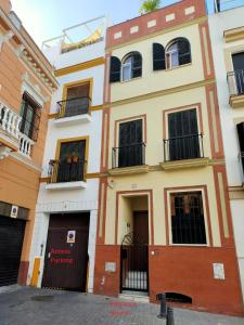 a building with two floors and two balconies at Unique House - Private SPA&Pool -StayInSeville in Seville