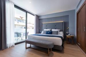 a bedroom with a large bed and a balcony at Hotel Lima - Adults Recommended in Marbella +37 photos