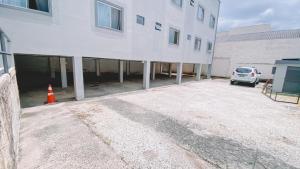 a car parked in a parking lot next to a building at Nacional Park Hotel Lages in Lages