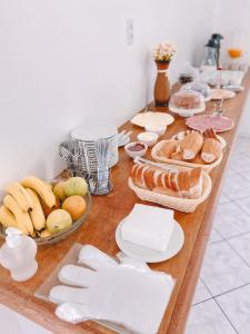 a long table with bread and other foods on it at Nacional Park Hotel Lages in Lages