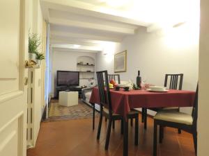comedor con mesa roja y sillas en Cesare Battisti Apartment en Bolonia