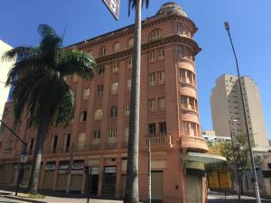 a tall brick building with a clock tower at Sul América Palace Hotel in Belo Horizonte