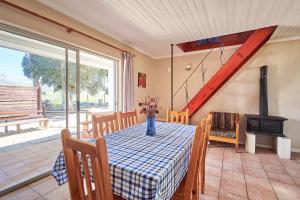 a dining room with a table and a wood stove at Citrus Creek Chalets in Citrusdal