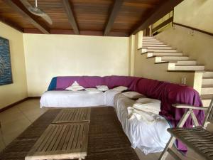 a large couch in a room with a staircase at Casa na praia in Mangaratiba