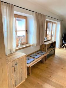 a room with wooden benches in a room with a window at APART24 in Kirchberg in Tirol