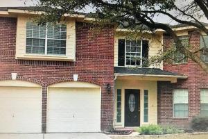 a red brick house with two garage doors at Katy, GRAND TEXAS SIZE HOUSE, 6 Bedrooms 14 Beds - Sedgecreek in Katy