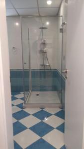 a bathroom with a shower with blue and white tiles at Stunning location and views!Foothills of Old town! in Plovdiv