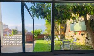 a window view of a patio with a table and chairs at Hostal Recreo in Viña del Mar