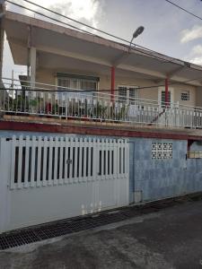 una casa con una valla blanca delante en Maison YZIDEE, en Fort-de-France 15 fotos más