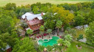 an aerial view of a house with a swimming pool at Moon River Ranch in Satin