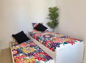 two beds with pillows on them in a room at Atalaya de Fornells in Fornells