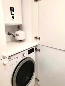 a washer and dryer in a small kitchen at Atalaya de Fornells in Fornells