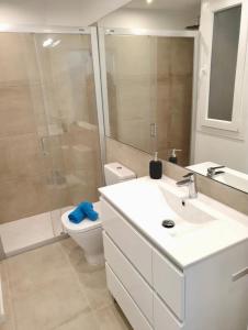 a bathroom with a sink and a toilet and a shower at Atalaya de Fornells in Fornells